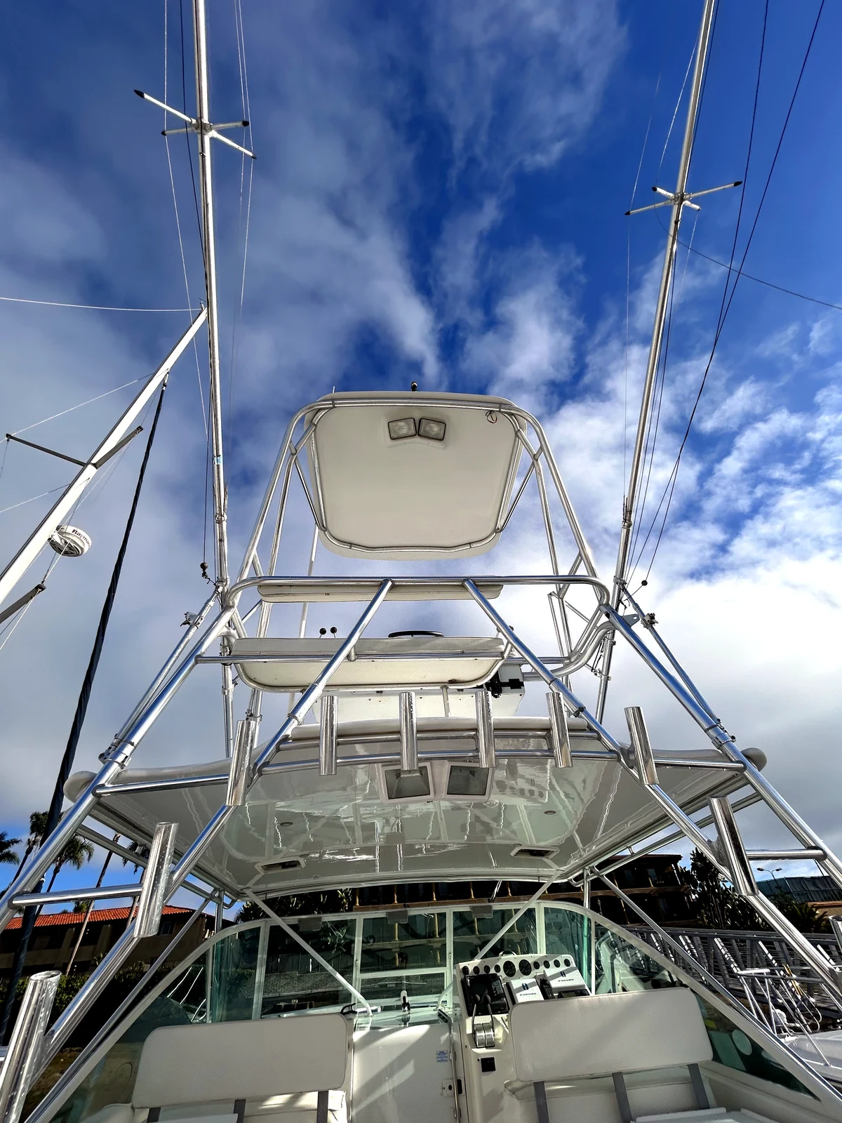 Sportfish yacht with mast and rigging against a dramatic blue sky