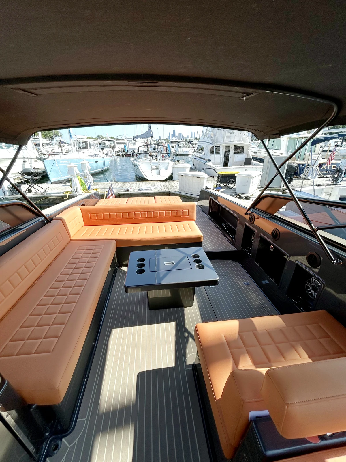 Yacht cockpit with tan leather seating and table ready for guests